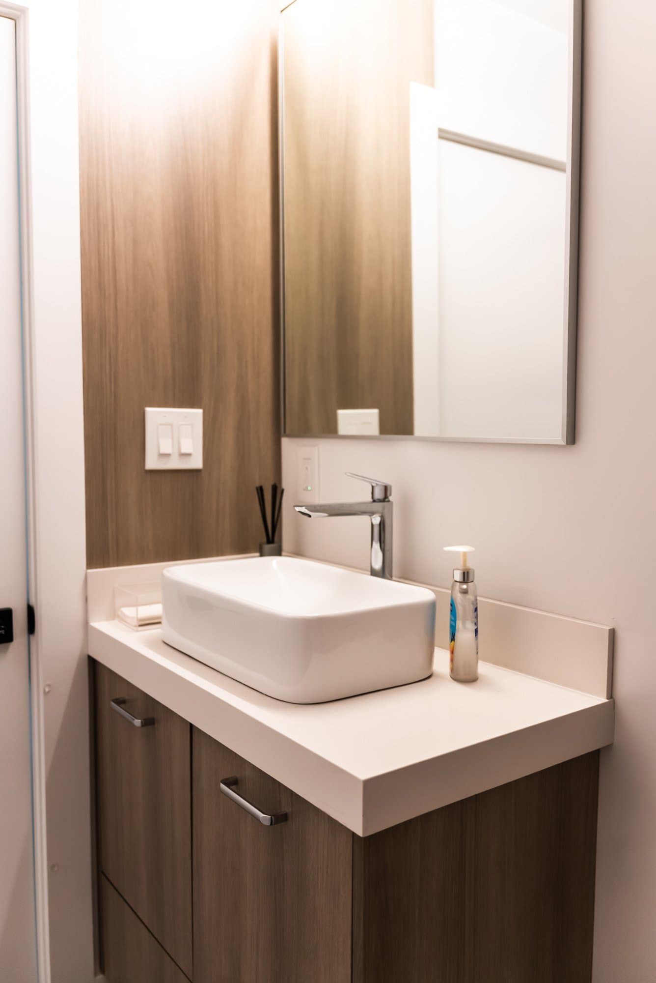 A wood vanity with a vessel sink on display in the Bay State Kitchen Gallery showroom