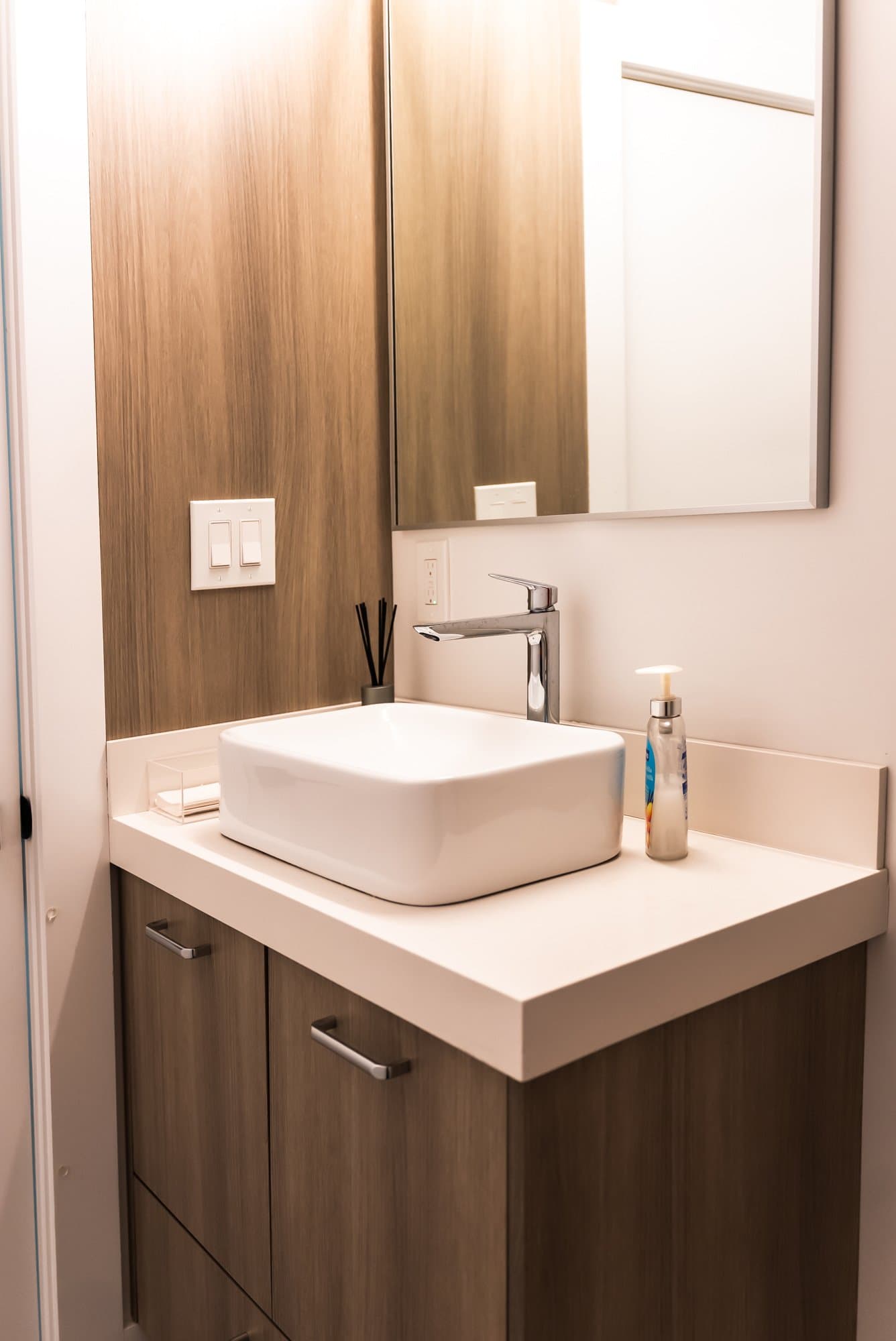 A wood vanity with a vessel sink on display in the Bay State Kitchen Gallery showroom in Waltham