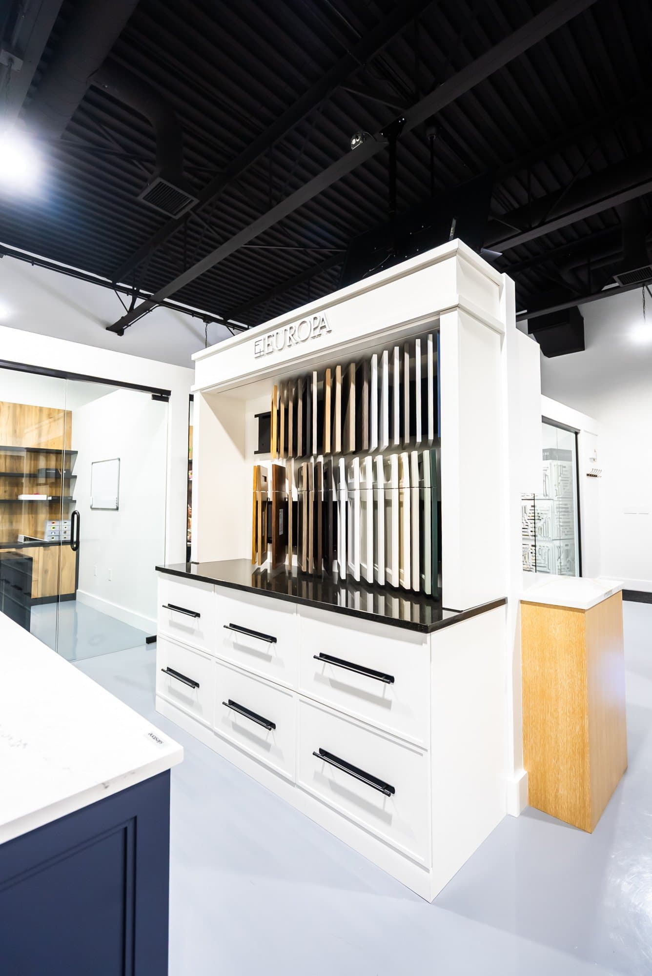 A bright cabinet and countertop display inside the Bay State Kitchen Gallery showroom