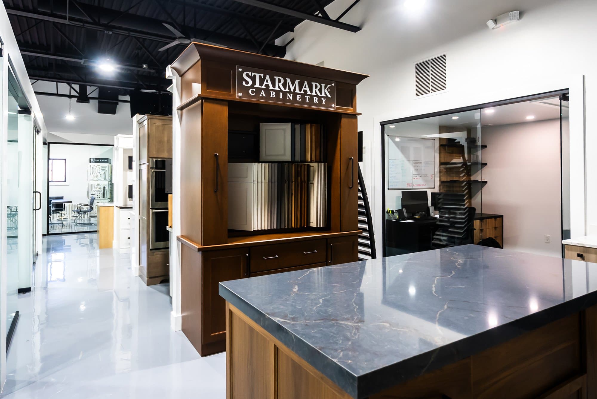 The Bay State Kitchen Gallery showroom floor in Waltham, with the StarMark display and a stone-topped island