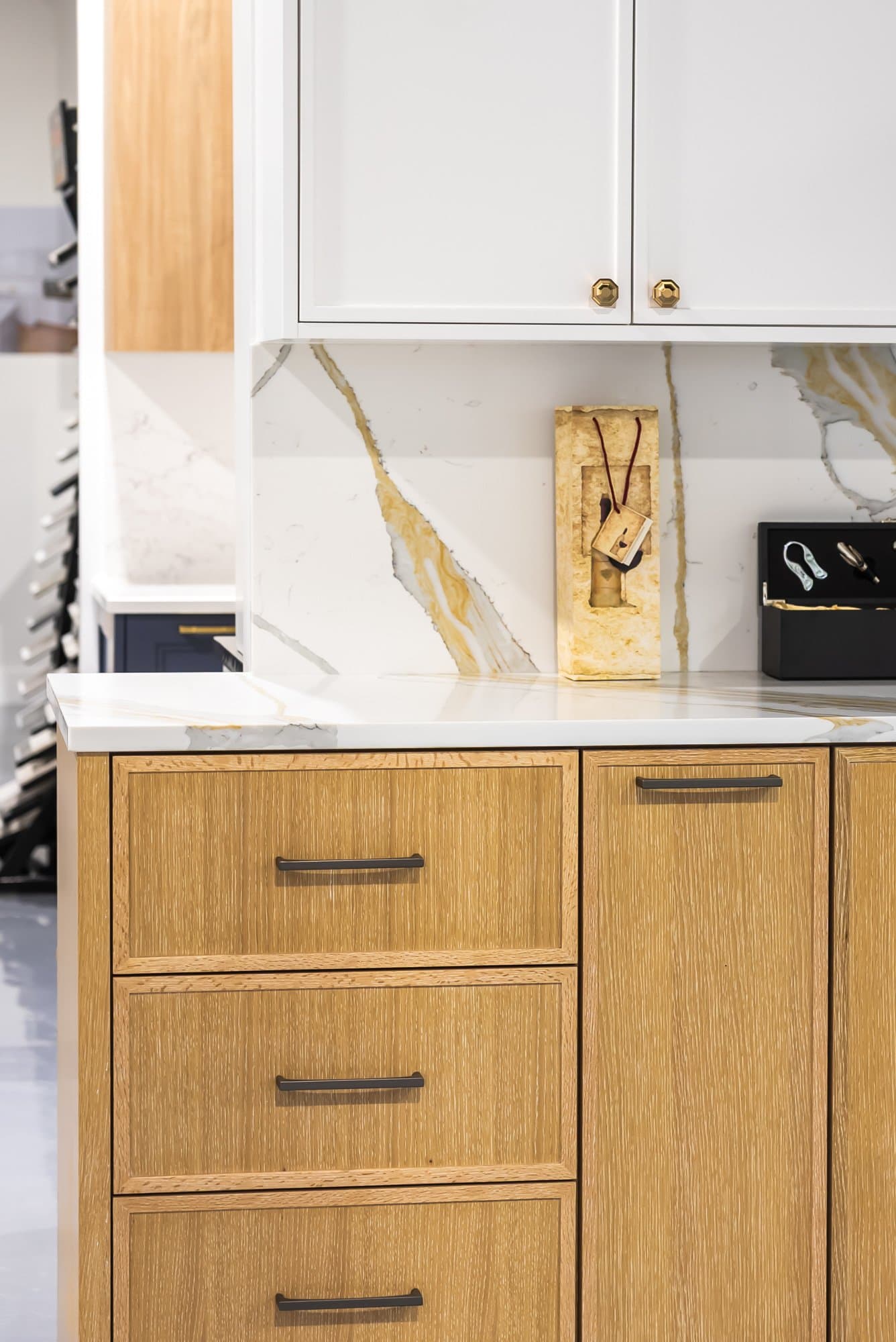 Countertop and backsplash over wood cabinets on display in the Bay State Kitchen Gallery showroom in Waltham
