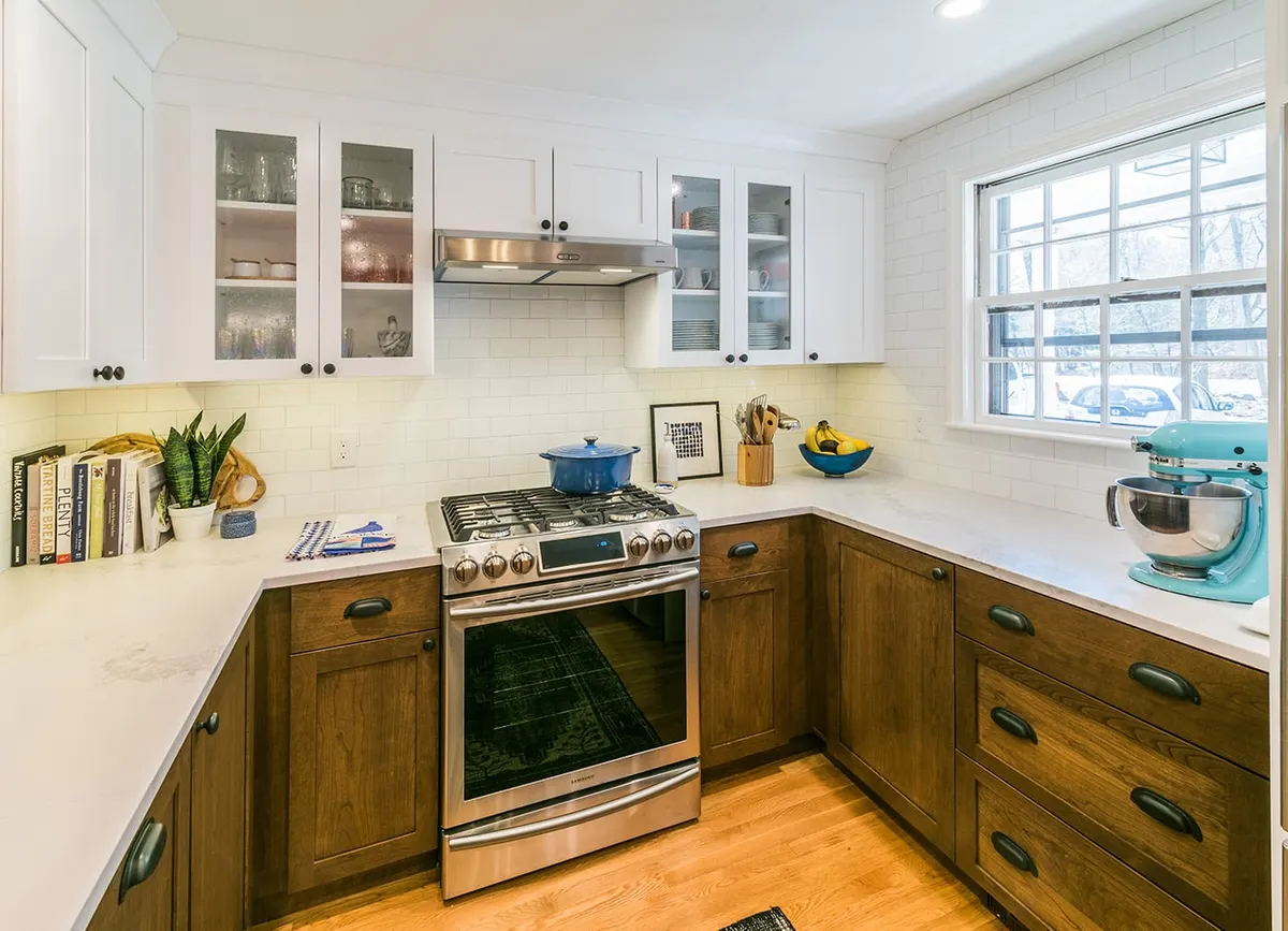 Walnut island with gold wire stools, open to a blue dining room, Wayland