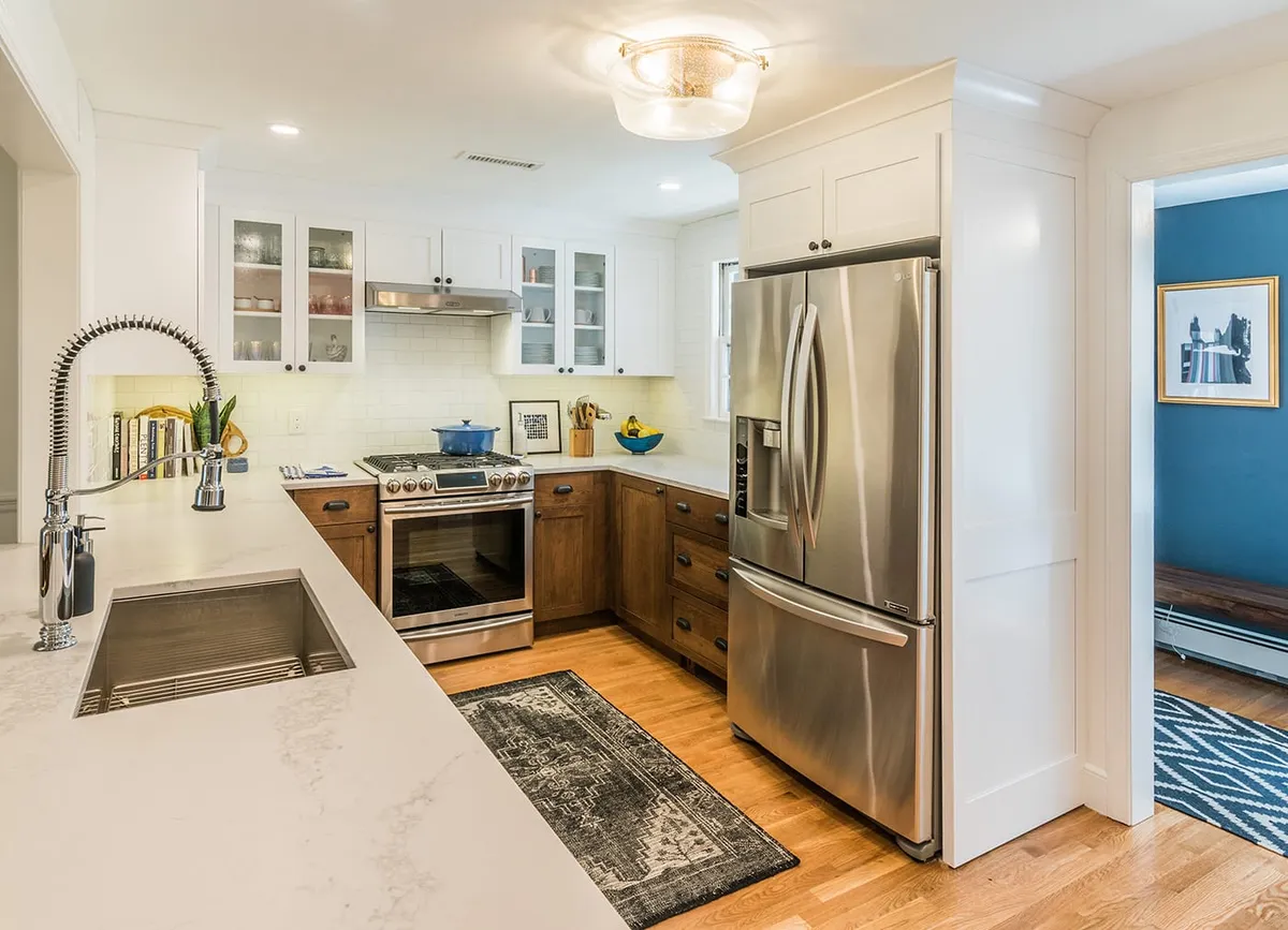 Wayland kitchen with stainless French-door fridge, subway tile backsplash, and walnut-stained cabinetry
