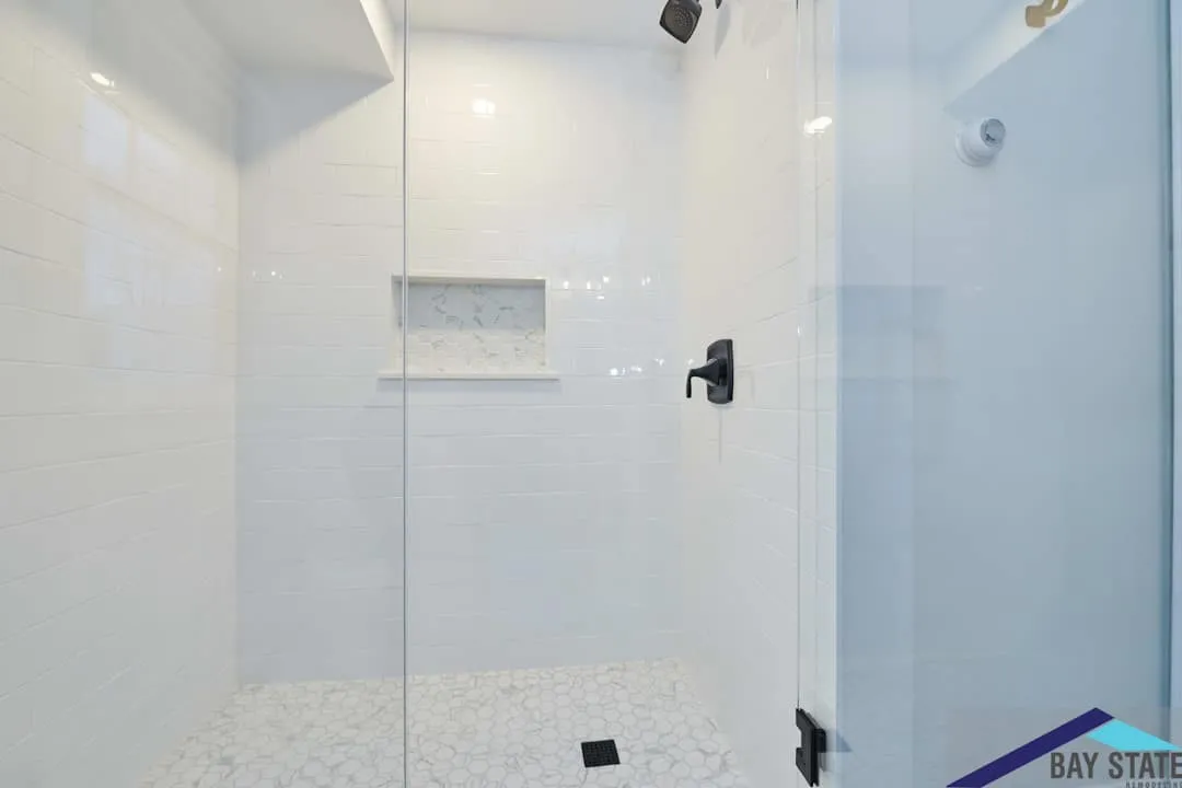 Arlington bathroom glass shower stall with white subway tile and a marble hex-tile floor
