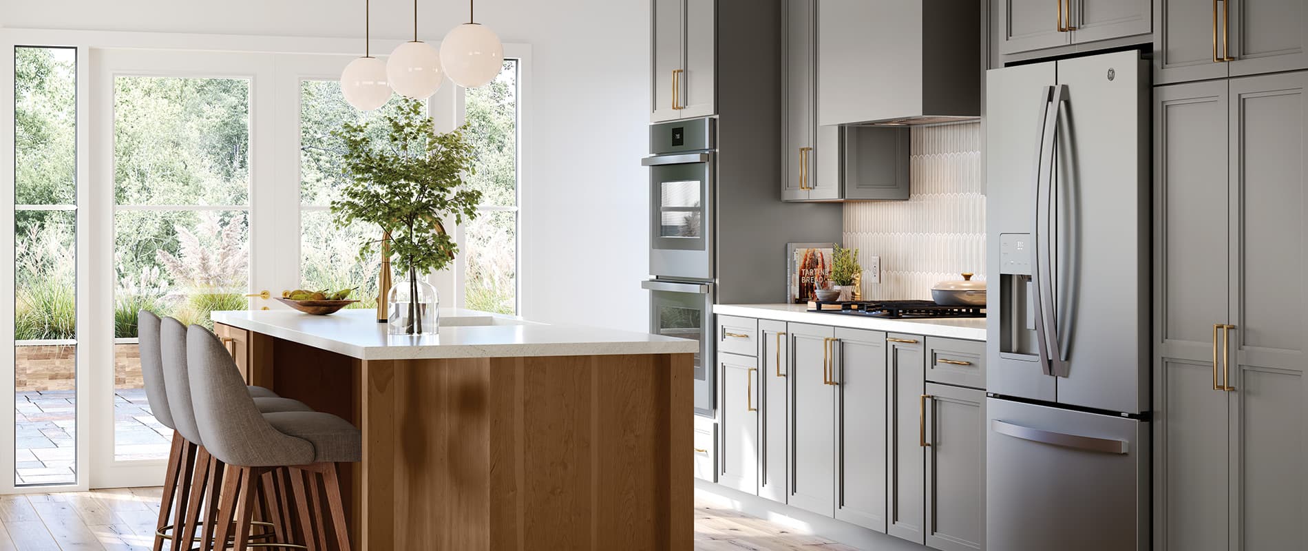 Mid Continent kitchen with gray shaker cabinets and brass pulls, a stained wood island and globe pendants, from the 2026 Style Files