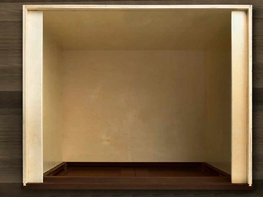 An open Fabuwood plywood cabinet box seen from the front